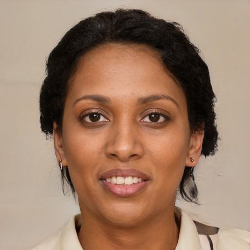Joyful black adult female with medium  brown hair and brown eyes