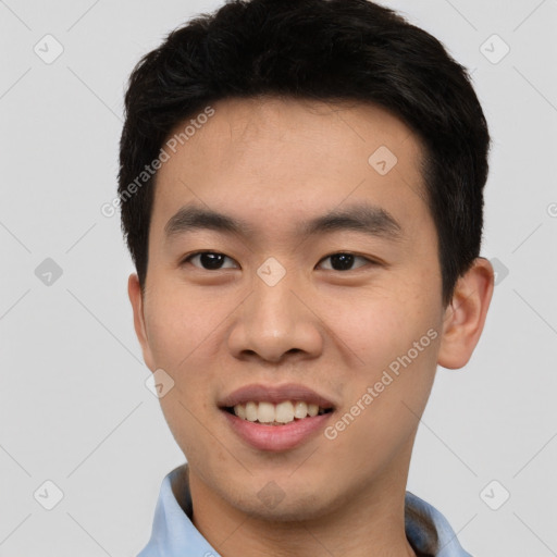 Joyful asian young-adult male with short  brown hair and brown eyes