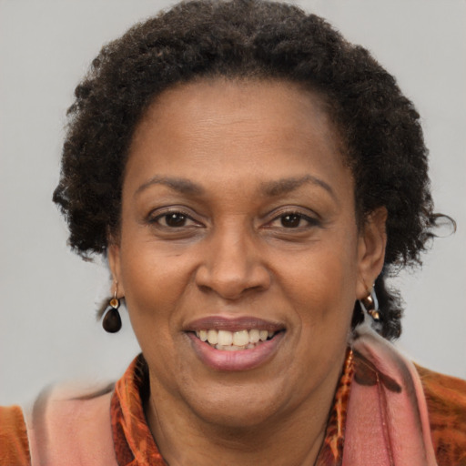 Joyful black adult female with short  brown hair and brown eyes