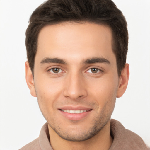 Joyful white young-adult male with short  brown hair and brown eyes