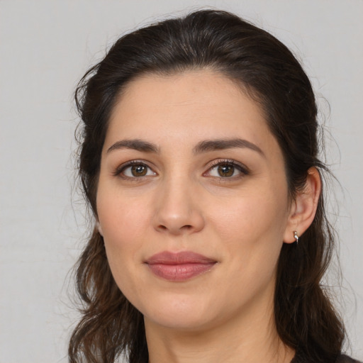 Joyful white young-adult female with long  brown hair and brown eyes