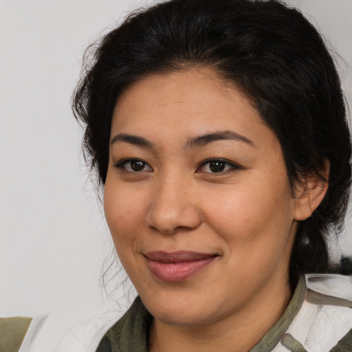 Joyful latino young-adult female with medium  brown hair and brown eyes