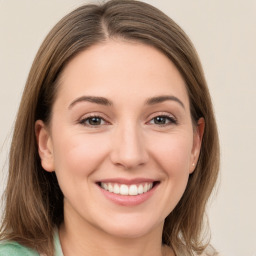 Joyful white young-adult female with medium  brown hair and green eyes