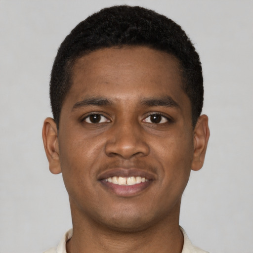 Joyful latino young-adult male with short  brown hair and brown eyes