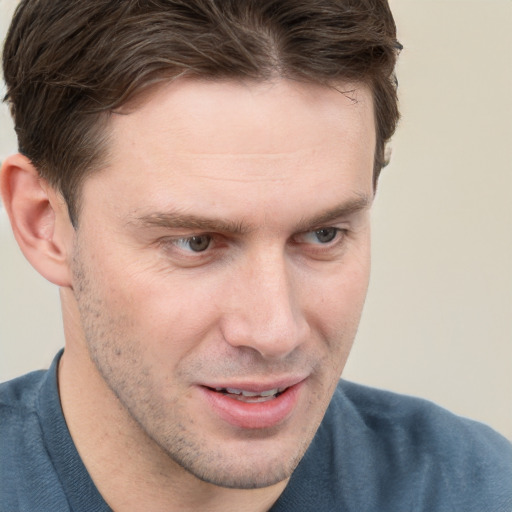 Joyful white adult male with short  brown hair and grey eyes