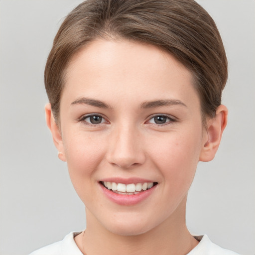 Joyful white young-adult female with short  brown hair and brown eyes