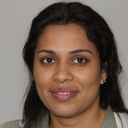 Joyful black young-adult female with medium  brown hair and brown eyes