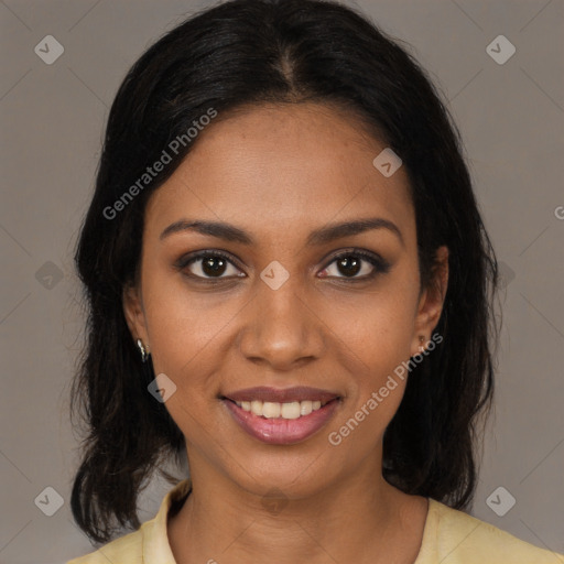 Joyful black young-adult female with long  brown hair and brown eyes