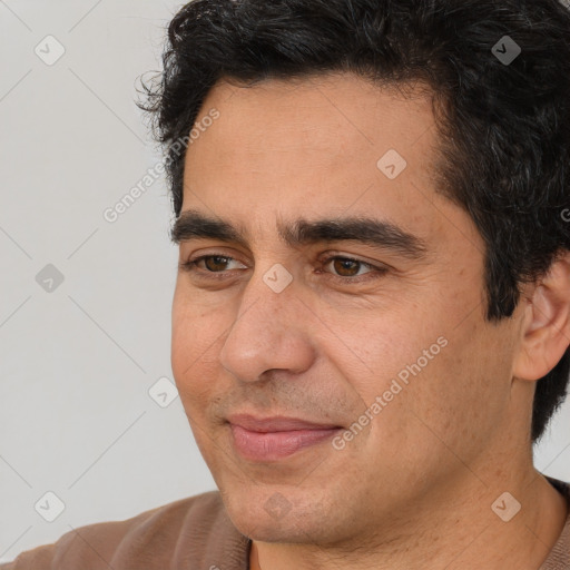 Joyful white adult male with short  black hair and brown eyes