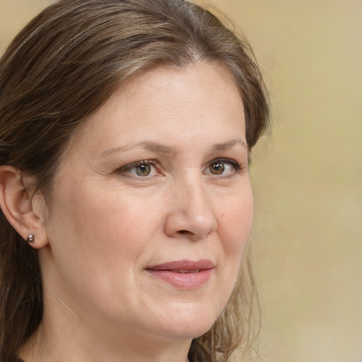 Joyful white adult female with medium  brown hair and grey eyes