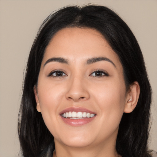 Joyful white young-adult female with long  black hair and brown eyes