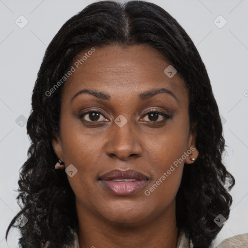 Joyful black adult female with long  brown hair and brown eyes