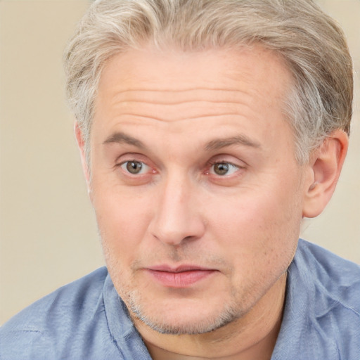 Joyful white adult male with short  brown hair and blue eyes