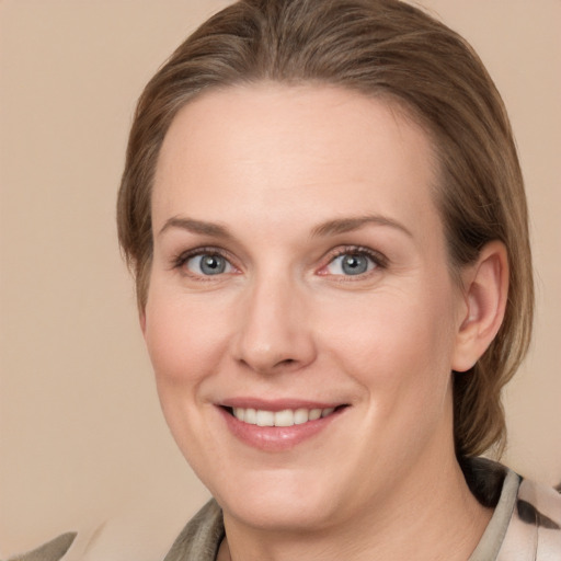 Joyful white young-adult female with medium  brown hair and grey eyes