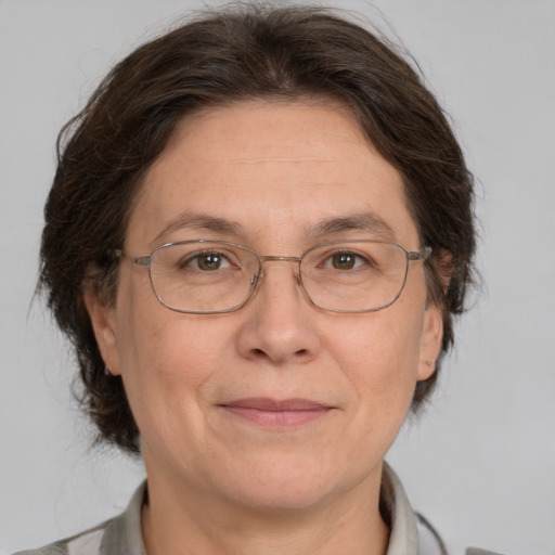 Joyful white middle-aged female with medium  brown hair and brown eyes