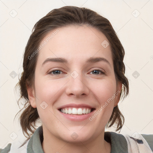 Joyful white young-adult female with medium  brown hair and grey eyes