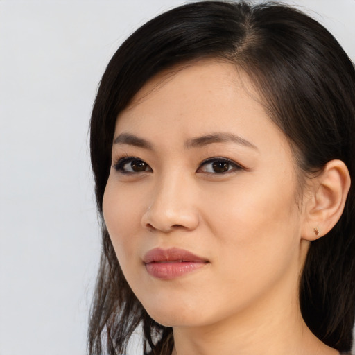 Joyful asian young-adult female with long  black hair and brown eyes
