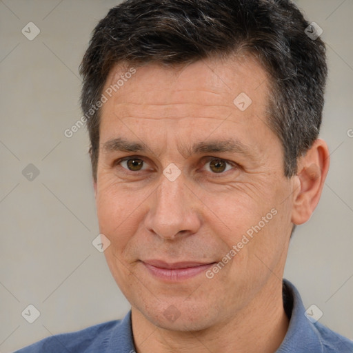 Joyful white adult male with short  brown hair and brown eyes