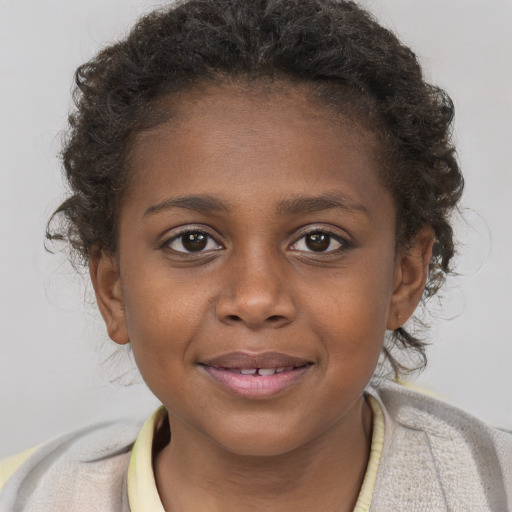 Joyful black child female with short  brown hair and brown eyes