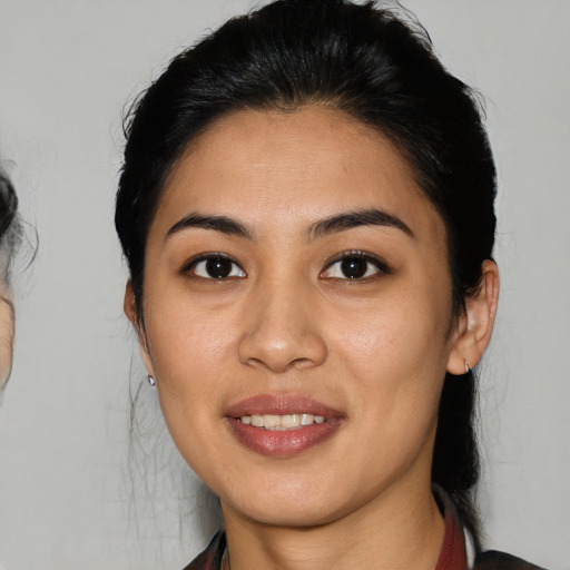 Joyful asian young-adult female with medium  brown hair and brown eyes