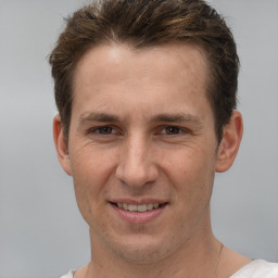 Joyful white adult male with short  brown hair and brown eyes