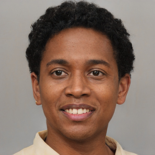 Joyful black young-adult male with short  brown hair and brown eyes