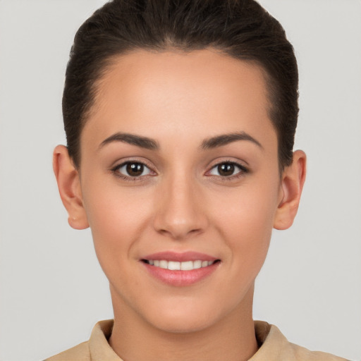 Joyful white young-adult female with short  brown hair and brown eyes