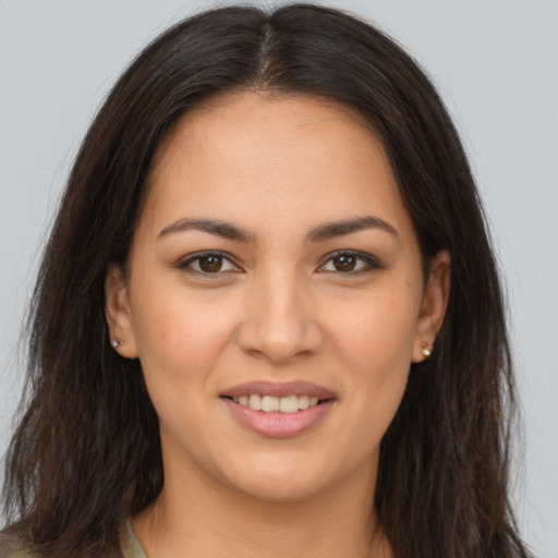 Joyful white young-adult female with long  brown hair and brown eyes