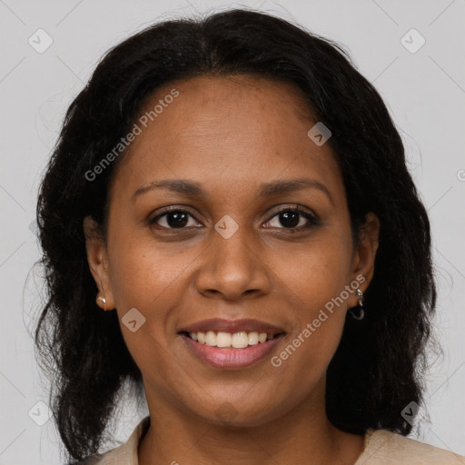 Joyful black adult female with long  brown hair and brown eyes