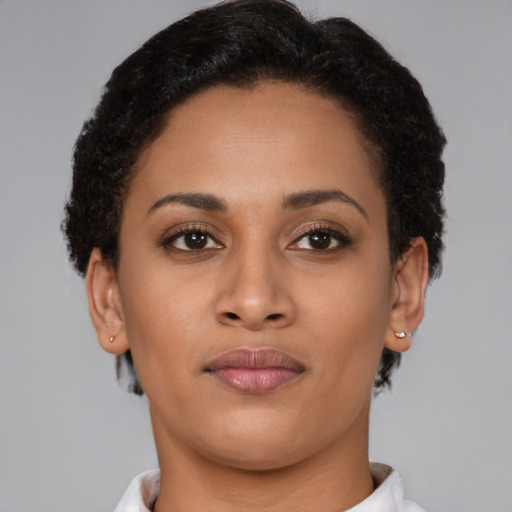Joyful latino young-adult female with short  brown hair and brown eyes