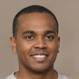 Joyful latino young-adult male with short  brown hair and brown eyes