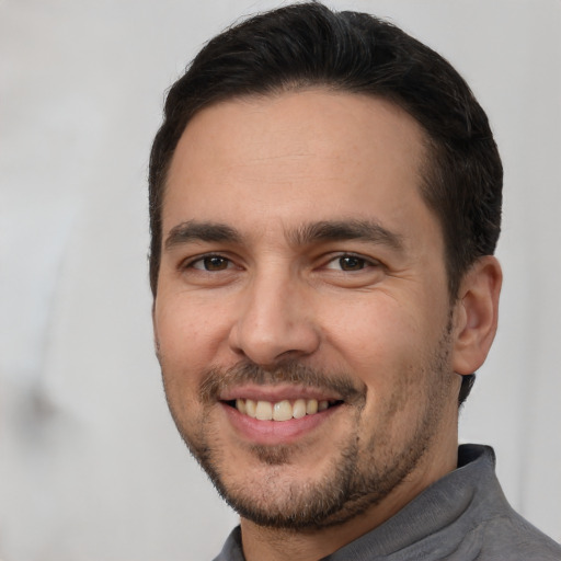 Joyful white adult male with short  brown hair and brown eyes