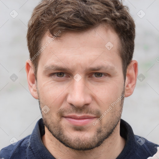 Joyful white young-adult male with short  brown hair and grey eyes