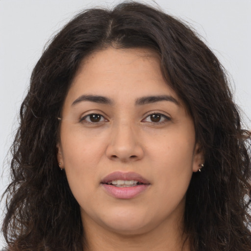Joyful latino young-adult female with long  brown hair and brown eyes