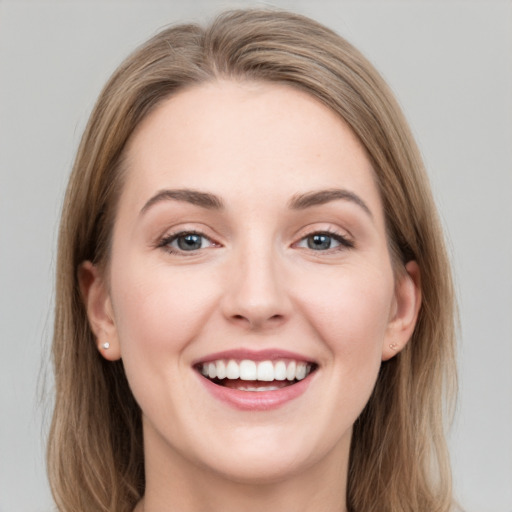 Joyful white young-adult female with medium  brown hair and green eyes