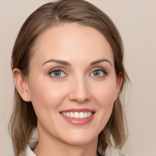 Joyful white young-adult female with medium  brown hair and blue eyes