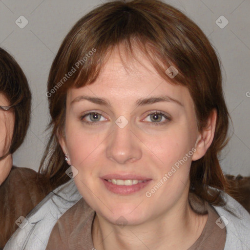 Joyful white young-adult female with medium  brown hair and blue eyes