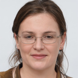 Joyful white adult female with medium  brown hair and grey eyes