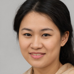 Joyful asian young-adult female with medium  brown hair and brown eyes