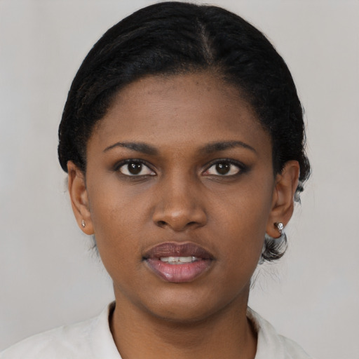 Joyful black young-adult female with short  black hair and brown eyes