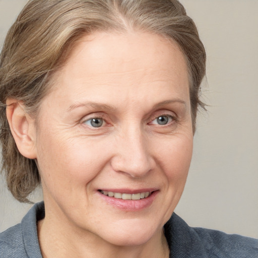 Joyful white adult female with medium  brown hair and blue eyes