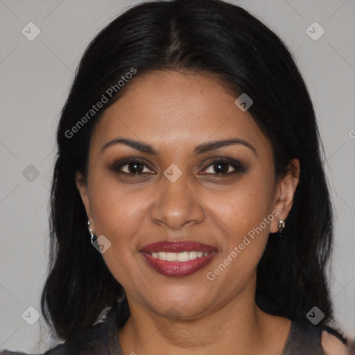 Joyful black young-adult female with long  brown hair and brown eyes