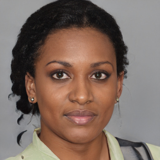 Joyful black young-adult female with medium  brown hair and brown eyes