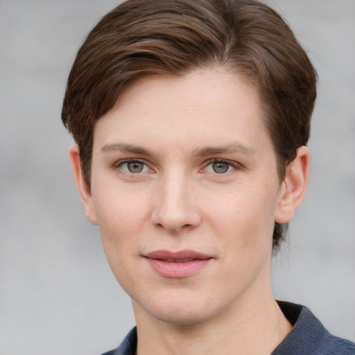 Joyful white young-adult female with short  brown hair and grey eyes