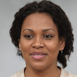 Joyful black adult female with medium  brown hair and brown eyes