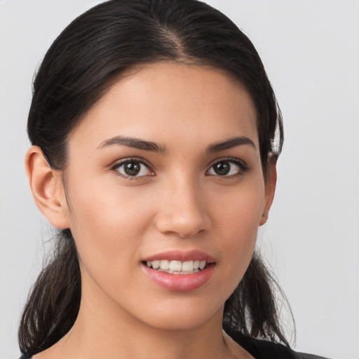 Joyful white young-adult female with long  brown hair and brown eyes