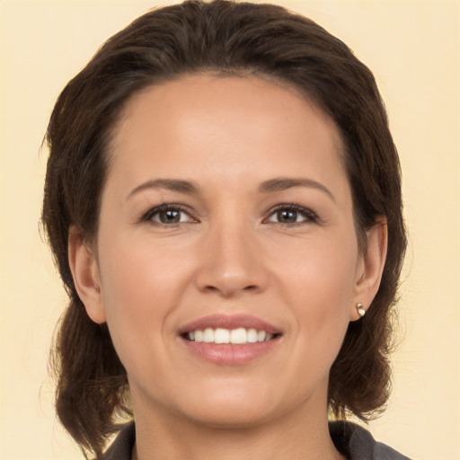 Joyful white young-adult female with medium  brown hair and brown eyes