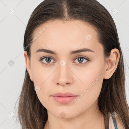 Neutral white young-adult female with long  brown hair and brown eyes