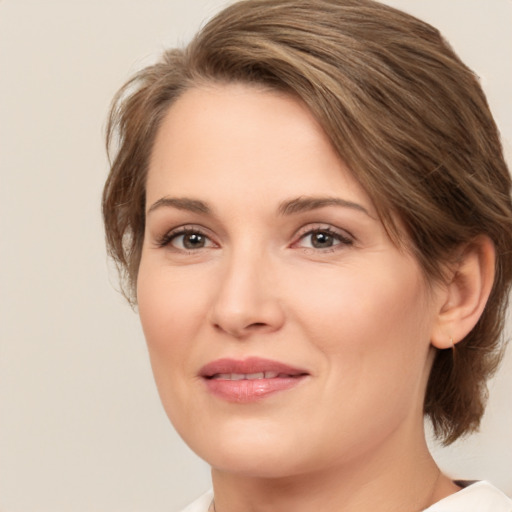 Joyful white adult female with medium  brown hair and brown eyes