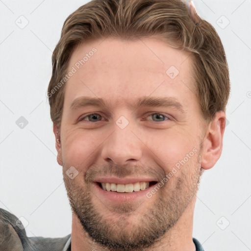 Joyful white young-adult male with short  brown hair and grey eyes